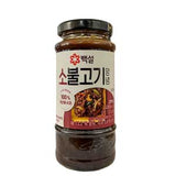 A glass jar of Beksul Bulgogi Sauce for Beef with a black lid and a white label featuring red and black text, photographed on a plain white background.