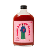 A bottle of Chimac Korean Hot Sauce with a pink label on a white background