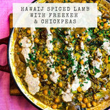 Hawaij spiced lamb recipe with freekeh and chickpeas in a pan on a pink background