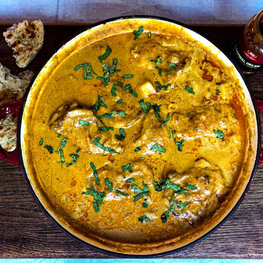 Malaysian Chicken Curry in a wide dish sprinkled with coriander