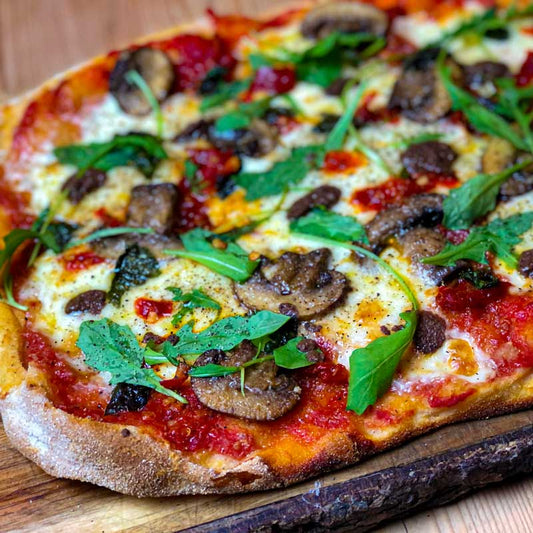 Pinsa Romana with Pepperoncini, fior di latte, mushrooms and rocket recipe for pizza