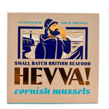 A square 110g box of Hevva! Cornish Mussels, featuring a vintage-style illustration of a sailor shouting towards the sea with a lighthouse in the background. The box is beige with pale blue and gold text and graphics.