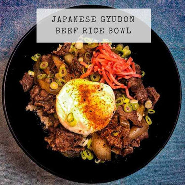Recipe  picture for Japanese Gyudon showing beef and rice in a black bowl with a poached egg and pickled ginger