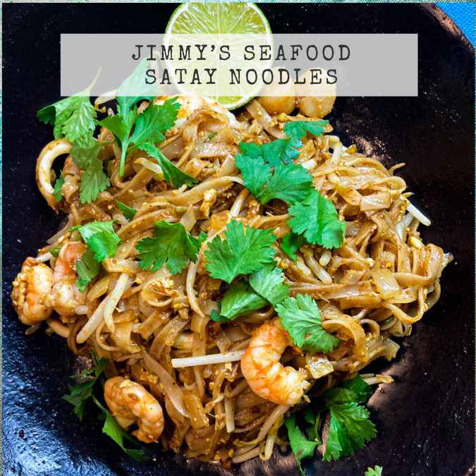 A picture of the recipe for Jimmy's Sate Seafood Noodles showing delicious rice noodles with juicy prawns and fresh coriander.