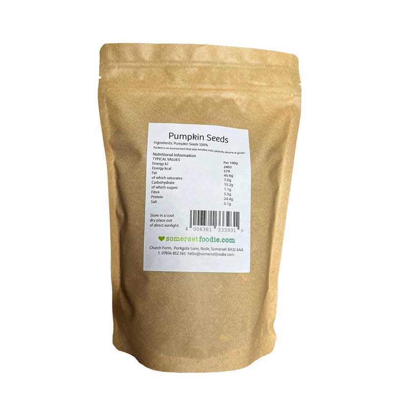 The reverse side of a Kraft paper style 500g bag of pumpkin seeds with a label on a white background