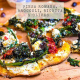 Recipe for Pinsa Romana pizza with broccoli, ricotta and olives on a wooden board.